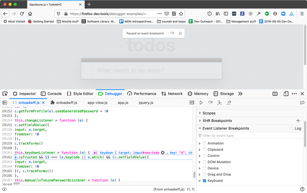 execution is paused on an event breakpoint and the source panel shows what line it is paused on